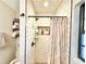 Bright bathroom showcasing a tiled shower with a built-in niche and black fixtures at 37807 Felkins Rd, Leesburg, FL 34788