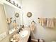Well-lit bathroom boasts a granite vanity with a decorative mirror and neutral decor at 37807 Felkins Rd, Leesburg, FL 34788