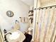 Stylish bathroom features a granite vanity, decorative mirror, and tiled shower at 37807 Felkins Rd, Leesburg, FL 34788