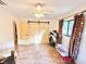 Spacious bedroom showcasing barn door closet, wood look flooring and bright windows at 37807 Felkins Rd, Leesburg, FL 34788