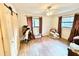 Spacious bedroom with ample natural light, wood look flooring, and barn door closet at 37807 Felkins Rd, Leesburg, FL 34788