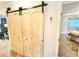 Hall closet featuring barn door with modern hardware, and entry to bedroom at 37807 Felkins Rd, Leesburg, FL 34788