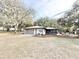 Home exterior with a garage, screened in porch and well maintained yard at 37807 Felkins Rd, Leesburg, FL 34788