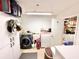 Functional laundry room with modern washer and dryer, ample storage, and utility sink at 37807 Felkins Rd, Leesburg, FL 34788