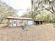 Exterior of an outbuilding with a metal roof, horse stable and wooden steps at 37807 Felkins Rd, Leesburg, FL 34788