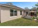 Well-maintained backyard showcasing the home's exterior and screened-in patio at 3812 Westerham Dr, Clermont, FL 34711