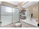 Well-maintained bathroom featuring a shower, sink, and storage shelves at 3812 Westerham Dr, Clermont, FL 34711