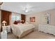Comfortable bedroom with ceiling fan, window and curtains, and a decorative dresser at 3812 Westerham Dr, Clermont, FL 34711