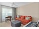Comfortable bedroom with a sofa, desk, and soft natural light at 3812 Westerham Dr, Clermont, FL 34711