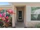 A close up of the front door, surrounded by colorful foliage and bright white shutters at 3812 Westerham Dr, Clermont, FL 34711