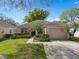 Charming single-story home showcasing well-maintained landscaping and a welcoming entrance at 3812 Westerham Dr, Clermont, FL 34711