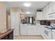 Clean kitchen featuring white cabinets, a dishwasher, and ample counter space at 3812 Westerham Dr, Clermont, FL 34711