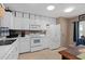 Bright kitchen featuring white appliances, ample storage, and plenty of counter space at 3812 Westerham Dr, Clermont, FL 34711