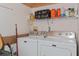 Functional laundry room with a modern washer and dryer and shelving for extra storage at 3812 Westerham Dr, Clermont, FL 34711