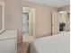 Spacious main bedroom with ensuite bathroom and view of the dining area at 3812 Westerham Dr, Clermont, FL 34711