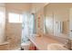 Bright bathroom featuring a window, tile floors, a tiled shower, and updated vanity at 4034 River Crest Cir, Leesburg, FL 34748