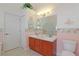 Clean bathroom featuring double sinks, decorative mermaid wall decor, and bright lighting at 4034 River Crest Cir, Leesburg, FL 34748