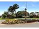 Picturesque water fountain at Plantation, surrounded by vibrant flowers, lush trees and blue skies at 4034 River Crest Cir, Leesburg, FL 34748
