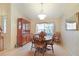 Traditional dining room featuring a wooden table set and large window at 4034 River Crest Cir, Leesburg, FL 34748