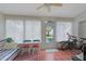 Bright Florida room with tile floors, many windows, and a ceiling fan at 4034 River Crest Cir, Leesburg, FL 34748