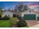 Charming single-story home featuring a well-maintained lawn and attached two-car garage at 4034 River Crest Cir, Leesburg, FL 34748