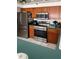 Bright kitchen showcasing stainless steel appliances, wooden cabinetry, and a tile floor at 4034 River Crest Cir, Leesburg, FL 34748