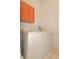 Inside the laundry room with a large white washer and dryer and wooden cabinets at 4034 River Crest Cir, Leesburg, FL 34748