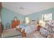 Cozy main bedroom with a ceiling fan, a wooden dresser, and lots of light from the windows at 4034 River Crest Cir, Leesburg, FL 34748