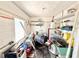 Cluttered laundry room with shelving and work bench at 410 W Seminole Ave, Eustis, FL 32726