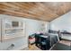 Bedroom featuring rustic wood ceilings, two windows providing ample light and a modern ceiling fan at 427 Brimming Lake Rd, Minneola, FL 34715