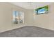 Empty bedroom with window and gray carpet at 509 Baytree Blvd, Tavares, FL 32778