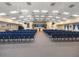 View of the auditorium with rows of blue chairs and stage at 5095 China Sea Dr, Tavares, FL 32778