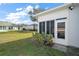 Cozy screened-in patio with manicured landscaping and lawn at 5095 China Sea Dr, Tavares, FL 32778