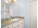 Bathroom vanity with a sink, large mirror and white cabinets below at 5095 China Sea Dr, Tavares, FL 32778