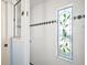 Shower with decorative glass window and tiled walls at 5095 China Sea Dr, Tavares, FL 32778