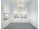 Bright dining room featuring a traditional chandelier and two windows overlooking the outdoor landscaping at 5095 China Sea Dr, Tavares, FL 32778