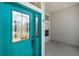 Bright teal front door with decorative glass panels welcomes you into this beautiful home at 5095 China Sea Dr, Tavares, FL 32778