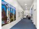 Hallway with art, display case, and an office at the end at 5095 China Sea Dr, Tavares, FL 32778