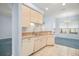Bright kitchen area with tile flooring and views to a connected carpeted living area at 5095 China Sea Dr, Tavares, FL 32778