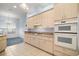 Well-lit kitchen with ample counter space, light wood cabinets and tile floors at 5095 China Sea Dr, Tavares, FL 32778