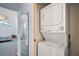 Stackable washer and dryer located next to bedroom at 5095 China Sea Dr, Tavares, FL 32778