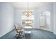 Inviting living room with a large window, chandelier, and comfortable seating area at 5095 China Sea Dr, Tavares, FL 32778