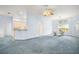 Spacious living room with a ceiling fan and adjacent dining area with large windows at 5095 China Sea Dr, Tavares, FL 32778
