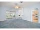 Open-concept living room with views of the sunroom and kitchen, perfect for modern living at 5095 China Sea Dr, Tavares, FL 32778