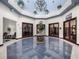 Elegant lobby with a chandelier, blue tile floors, and seating areas at 5095 China Sea Dr, Tavares, FL 32778