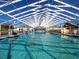Indoor pool with a large open ceiling, and lounge chairs at 5095 China Sea Dr, Tavares, FL 32778