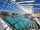 Indoor pool and hot tub with a large open ceiling, and plenty of lounge chairs at 5095 China Sea Dr, Tavares, FL 32778