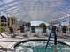 Indoor pool area with a jacuzzi in the foreground and lounge chairs at 5095 China Sea Dr, Tavares, FL 32778