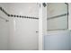 Tiled shower with glass door and decorative tile border at 5095 China Sea Dr, Tavares, FL 32778