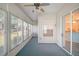 Bright sunroom featuring carpet, a ceiling fan, and multiple windows for natural light at 5095 China Sea Dr, Tavares, FL 32778